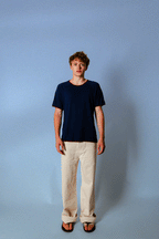 Model wearing the Soleil Lune Base Shirt in navy with contrast stitching. Made from 55% hemp and 45% organic cotton, featuring a relaxed fit, breathable natural texture, and soft drape styled in a minimal studio setting.